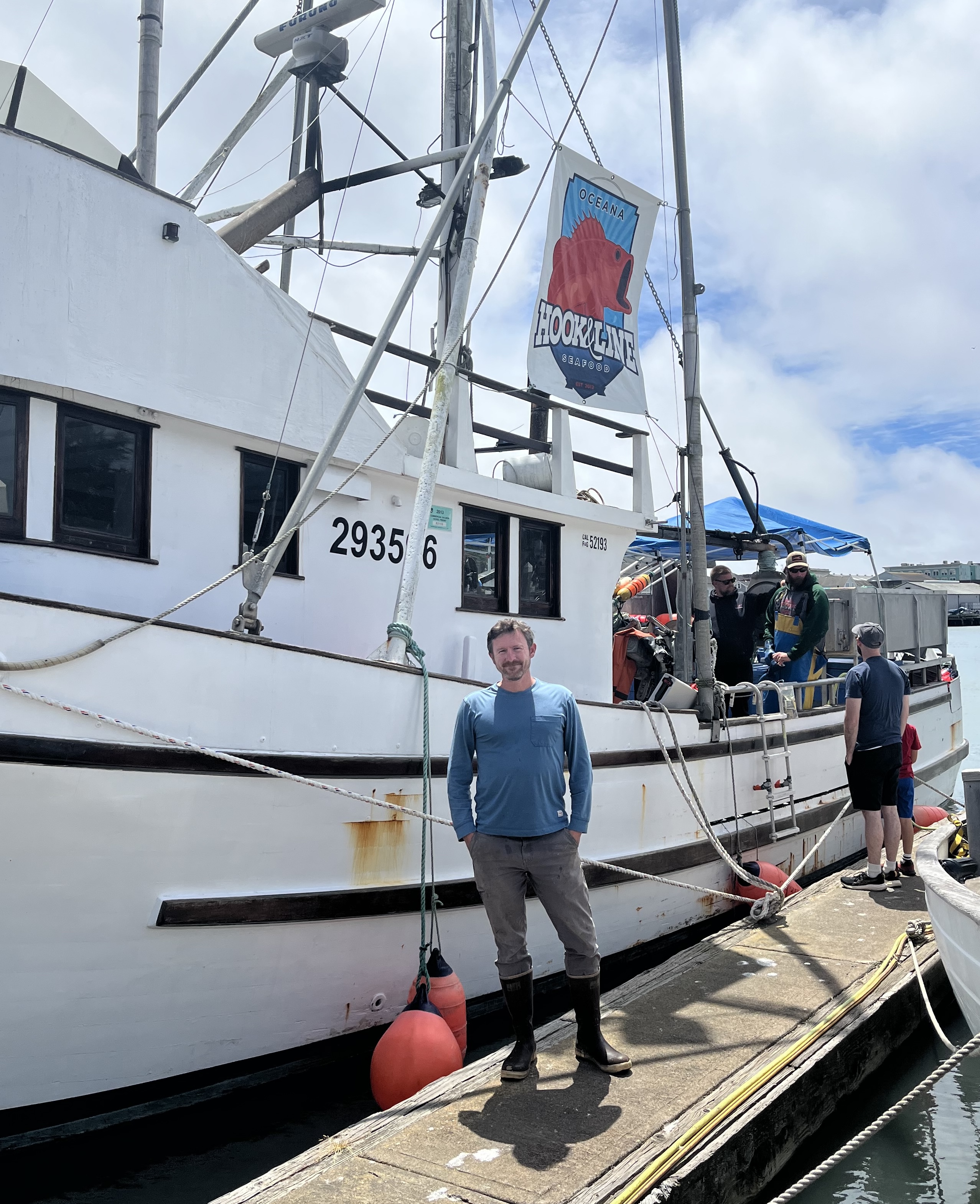 Harrison in front of his fishing vessel 
