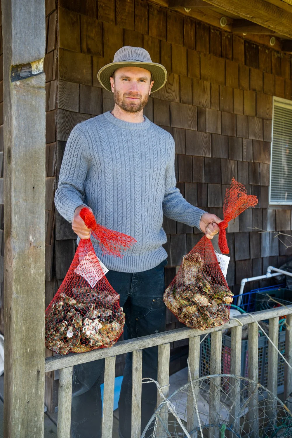 Whittaker holding bags of oysters 
