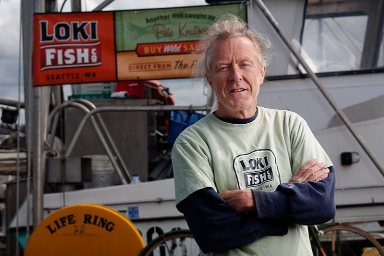 Pete Knutson poses with arms crossed in front of Loki Fish Company