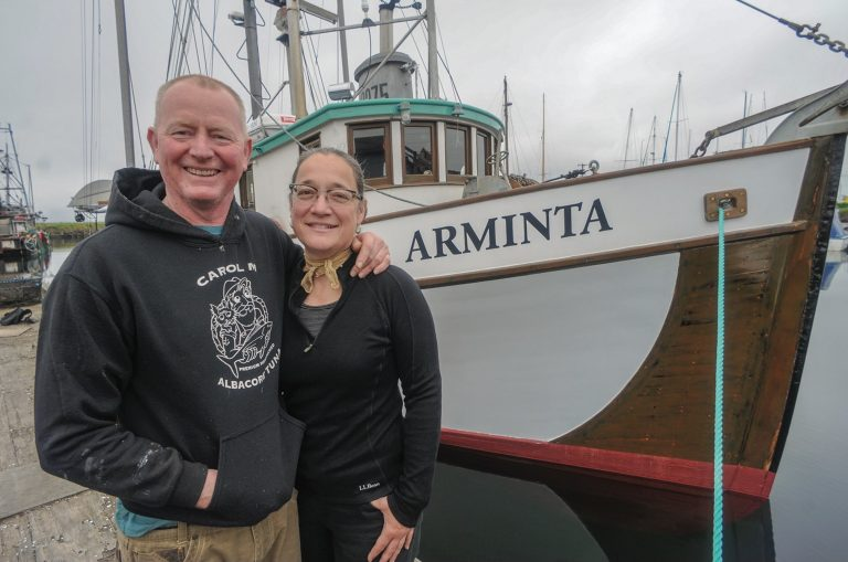 Amy Grondin, salmon fisherman and sustainable seafood consultant, poses with her partner and husband Greg Friedrichs in from of their boat, the Arminta.