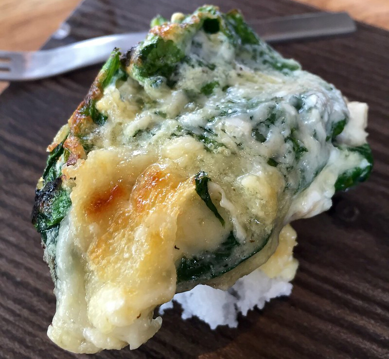 Oyster half shell with spinach, roasted oyster and melted cheese