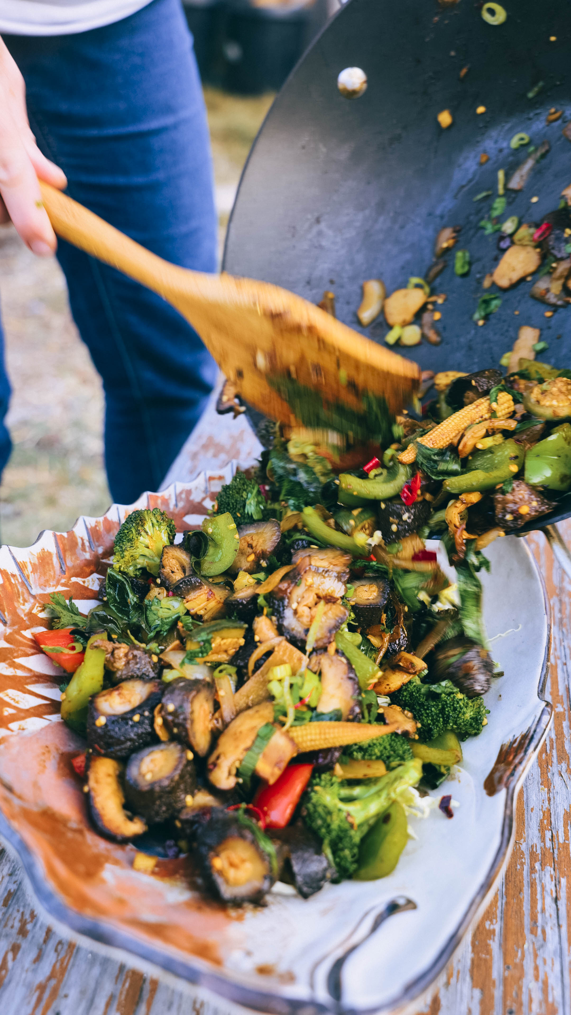 person plating sea cucumber stir fry 