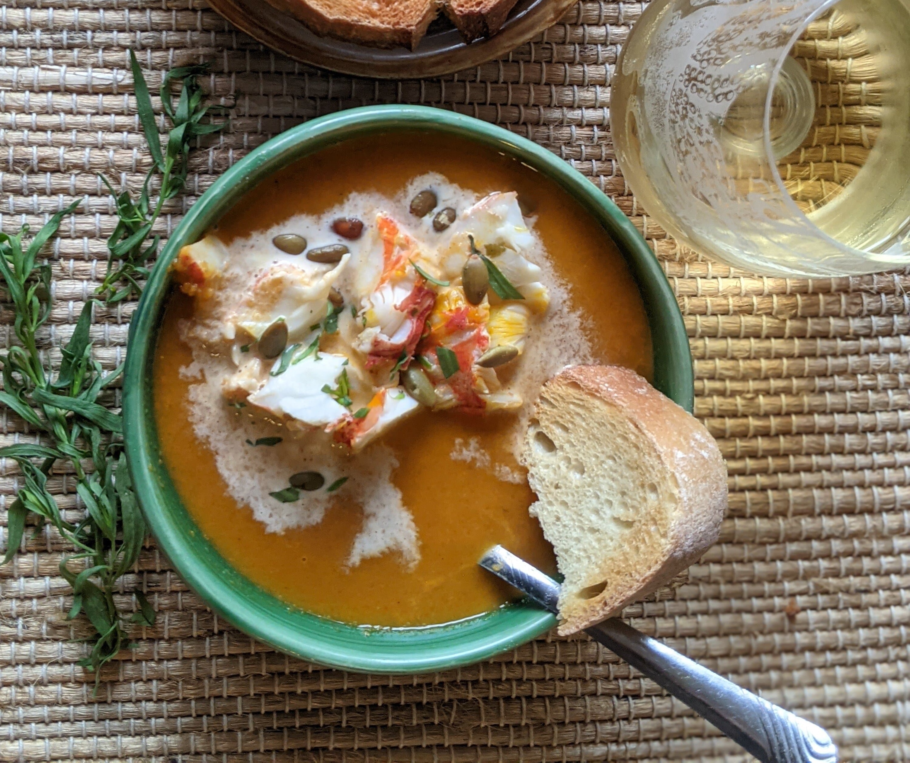 spiny lobster pumpkin bisque in a bowl with bread