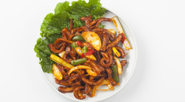 Stir fried hagfish on plate with lettuce garnish