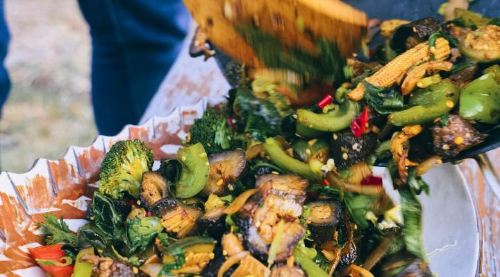 person plating sea cucumber stir fry 