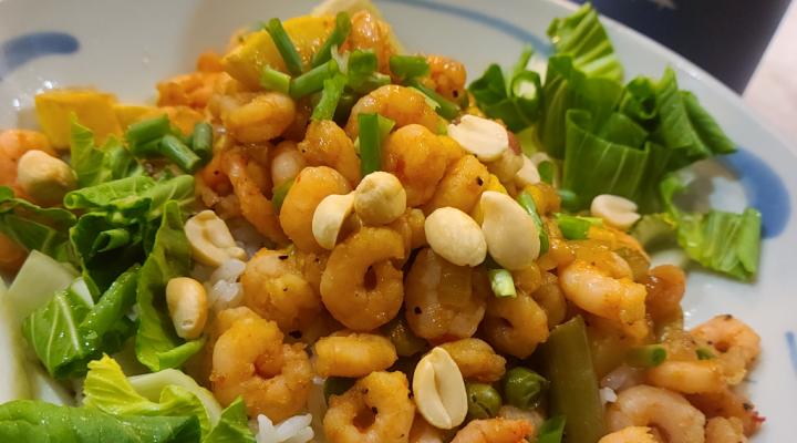 Shrimp and peanut stir-fry on greens