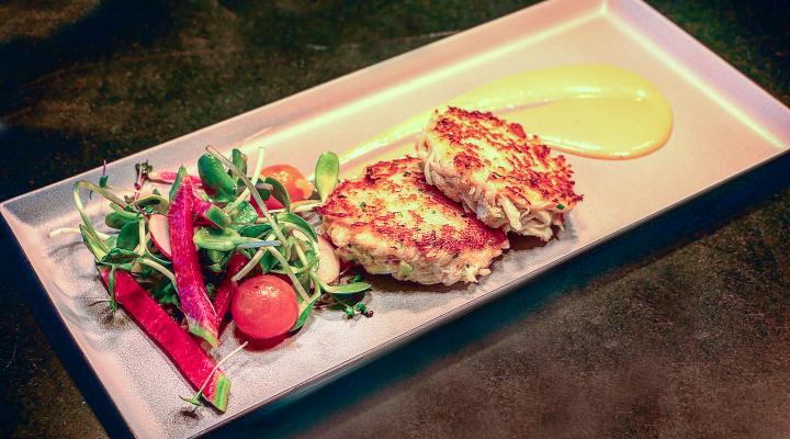 Meridian Dungeness crab cakes on a plate with sauce