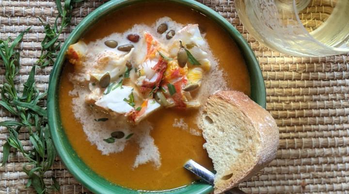 spiny lobster pumpkin bisque in a bowl with bread