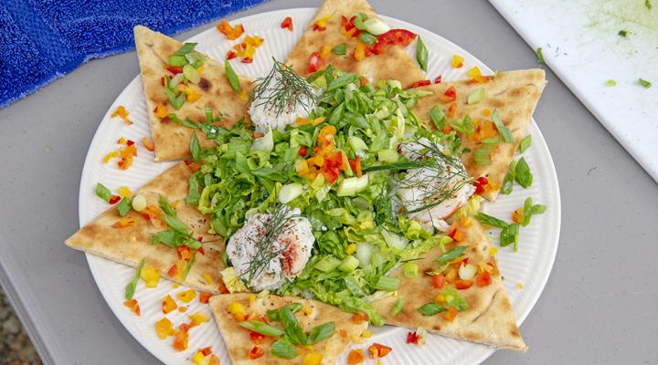 Plate with crab salad on top of six slices of pita placed around the plate