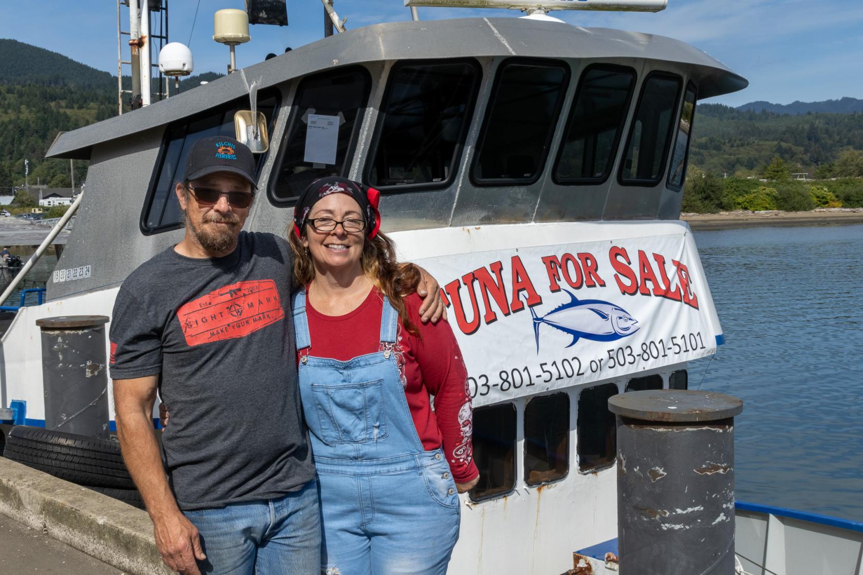 Gary and Deborah Motsinger stand in front of fishing vessel Two Captains