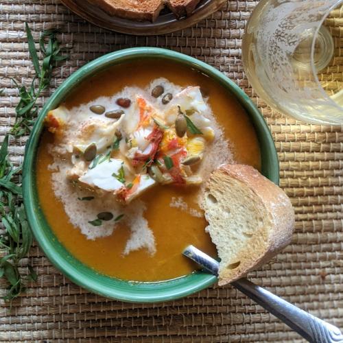 spiny lobster pumpkin bisque in a bowl with bread