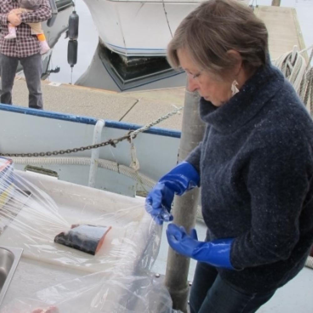 women wrapping a fish